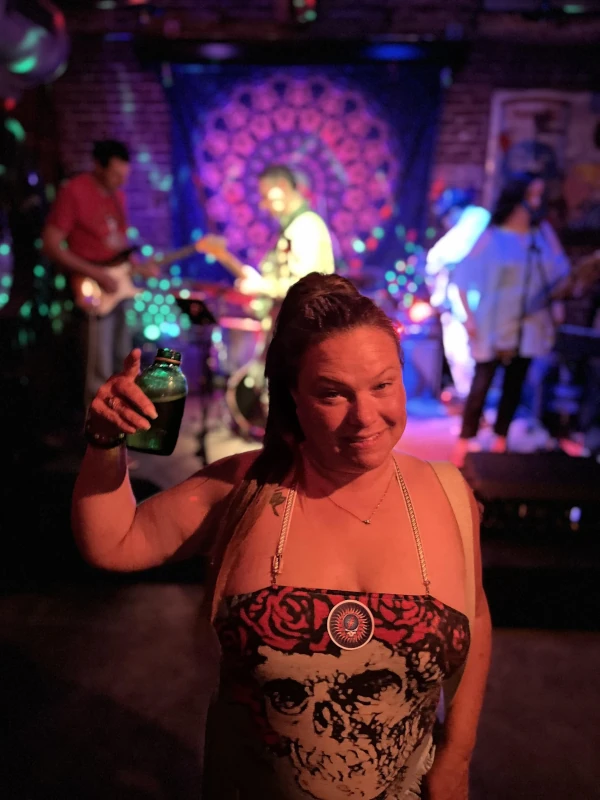 Posing with a drink at Speakeasy in Carrboro with live music in background