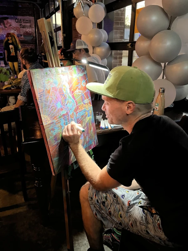 Man painting art at Speakeasy in Carrboro