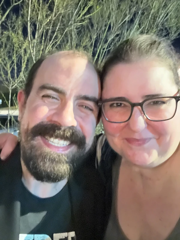 Two people posing together in front of the camera at Speakeasy