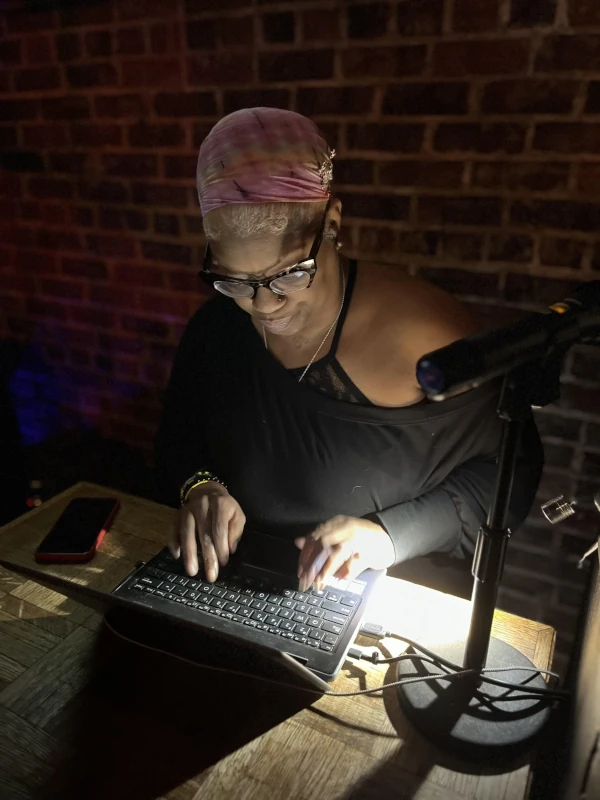 Woman infront of a laptop at Speakeasy